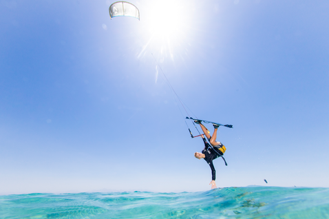 Duotone Shred twin-tip kiteboard during kitesurfing in tropical ocean with shallow turquoise water