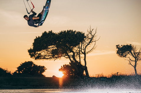 Duotone Team Series SLS twin-tip kiteboard during kitesurfing in a coastal lagoon in Sardinia