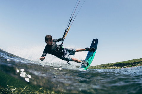 Duotone Team Series SLS twin-tip kiteboard during kitesurfing in a coastal bay