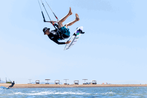 Duotone Slash SLS kitesurfboard while kitesurfing on the ocean beach