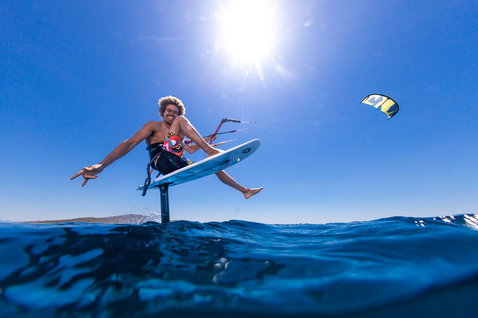Duotone Hybrid SLS kite surfboard during foiling on the open ocean with clear blue water