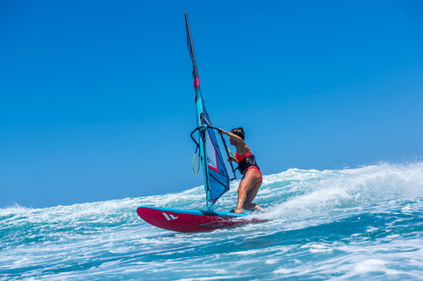 Duotone FreeWave windsurf board during wave riding at the ocean beach