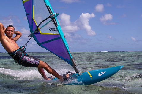 Duotone FreeWave SLS windsurf board during windsurfing in a tropical shallow water lagoon with coral reef