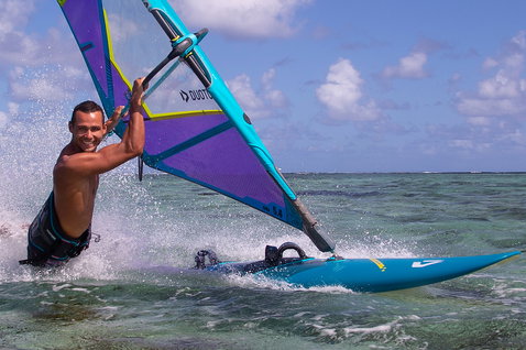 Duotone FreeWave SLS windsurf board during wave riding in a tropical ocean lagoon