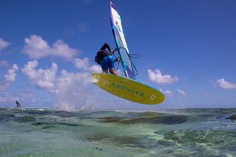 Duotone FreeWave SLS windsurf board during wave riding at a tropical ocean reef break