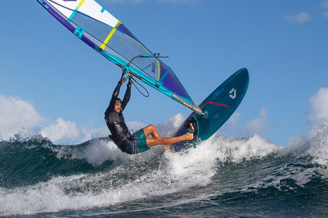 Duotone FreeWave SLS windsurf board during wave riding at an ocean wave break
