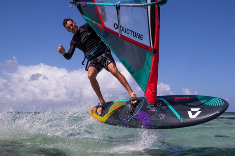 Duotone Skate SLS windsurf board during freestyle windsurfing in a tropical lagoon with shallow turquoise water