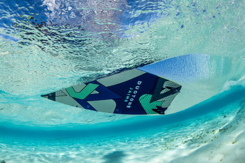 Duotone Jaime twin-tip kiteboard in tropical shallow water at an ocean beach