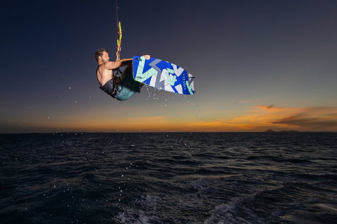 Duotone Jaime twin-tip kiteboard during kitesurfing on open ocean water at sunset