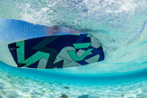 Duotone Jaime twin-tip kiteboard during kitesurfing in shallow water over a sandy bottom in a tropical ocean