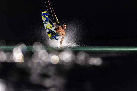 Duotone Jaime SLS twin-tip kiteboard during kitesurfing in the ocean at night