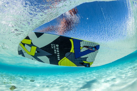 Duotone Jaime SLS twin-tip kiteboard during kitesurfing in shallow water over a sandy reef bottom in a tropical ocean