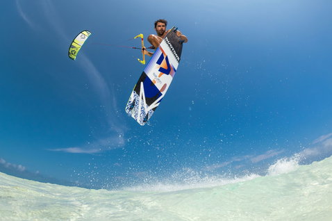 Duotone Select SLS twin-tip kiteboard during kitesurfing in tropical shallow turquoise ocean