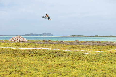 Duotone Select SLS twin-tip kiteboard during kitesurfing at a tropical coastal lagoon