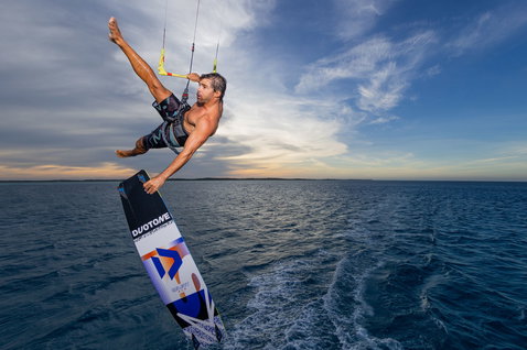Duotone Select SLS twin-tip kiteboard during kitesurfing at an ocean beach