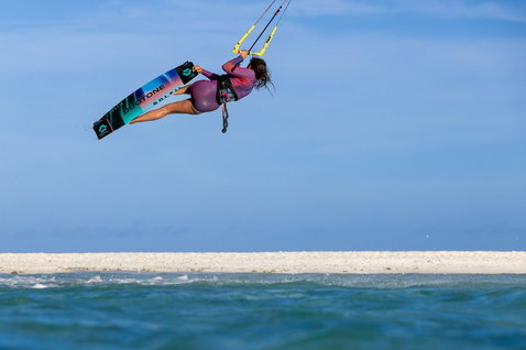 Duotone Soleil Concept Blue twin-tip kiteboard during kitesurfing in turquoise shallow water with white sand bar
