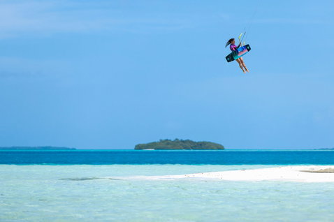 Duotone Soleil Concept Blue twin-tip kiteboard during kitesurfing at a tropical ocean beach with sandbar
