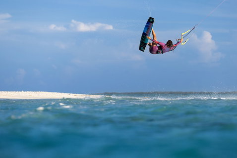 Duotone Soleil Concept Blue twin-tip kiteboard during kitesurfing in shallow turquoise ocean water