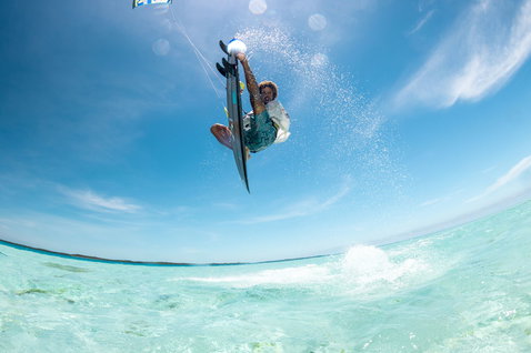 Tabla de kitesurf Duotone Volt SLS Concept Blue durante el kitesurf en una laguna tropical de aguas cristalinas