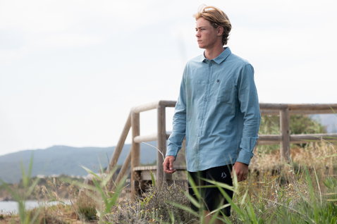 Duotone Apparel Shirt Breeze LS unisex long sleeve shirt worn at a coastal meadow with hills and sea in the background