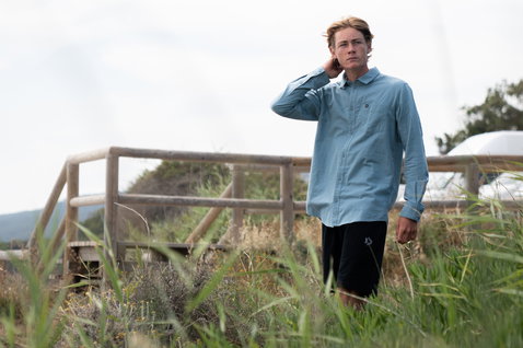 Duotone Apparel Shirt Breeze LS unisex long sleeve shirt in light blue during a standing pose on coastal grassland