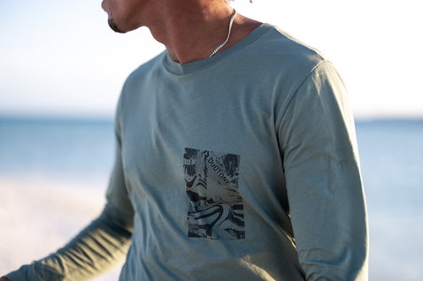 Camiseta de manga larga Duotone Kiteboarding Tee Team LS Concept Blue en verde salvia en la playa
