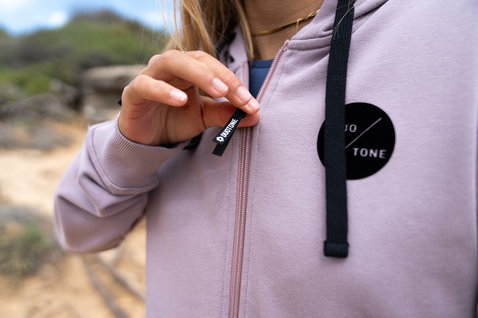 Duotone Apparel Hoody Team Zip femme sweat zippé en mauve lavande dans un paysage rocheux extérieur