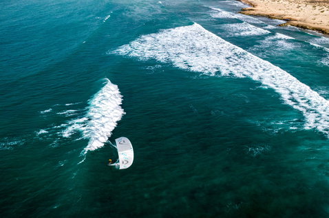 Duotone Neo Concept Blue LEI kite during wave riding at an ocean beach