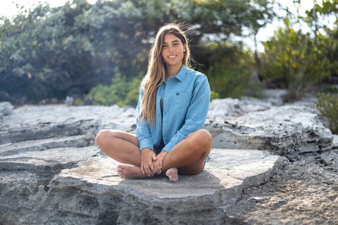 Duotone Apparel Shirt Breeze LS unisex long sleeve shirt in light blue on a rocky coastal outcrop with vegetation