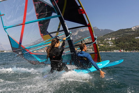 Duotone Eagle SLS windsurf board while windsurfing on an alpine lake
