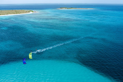 Duotone Neo SLS LEI kite during kitesurfing in a tropical ocean lagoon with sandy island