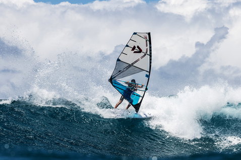 Duotone Super Hero D/LAB wave sail during wave riding at an ocean beach