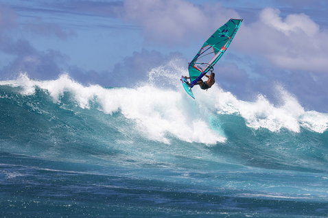 Duotone Grip 3 SLS windsurf board during wave riding at an ocean beach