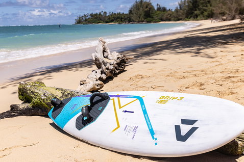 Duotone Grip 3 D/LAB windsurf board during windsurfing at a tropical beach with turquoise water