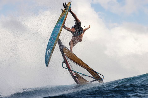 Duotone Grip 4 SLS windsurf board during wave riding on the ocean with breaking waves