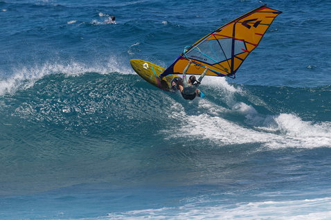 Duotone Grip 4 SLS windsurf board while wave riding at the ocean wave break