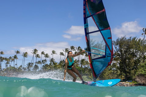 Duotone Ultra FreeWave 2025 windsurf board during wave riding at a tropical ocean beach