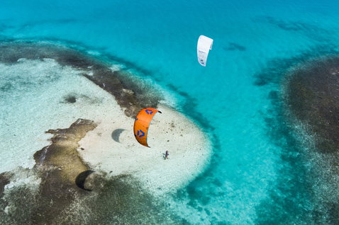 Duotone Rebel SLS Concept Blue 2025 LEI kite during kitesurfing over a tropical shallow reef lagoon