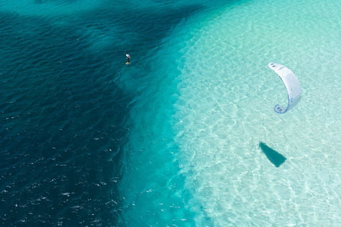 Duotone Rebel SLS Concept Blue LEI kite during kitesurfing in shallow turquoise water over sandbar