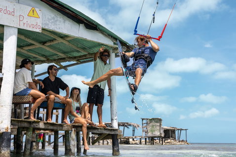 Duotone Rebel SLS LEI kite during kitesurfing at a tropical coastal pier