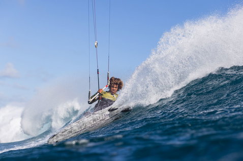 Duotone Whip D/LAB kite surfboard during kitesurfing on an open ocean wave