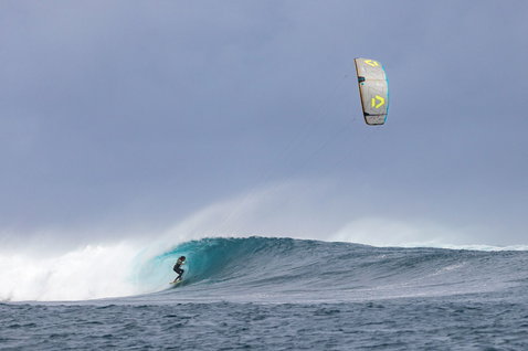 Team traction pad during wave riding on an ocean wave in open sea
