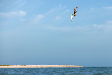 Duotone Jaime Concept Blue twin-tip kiteboard during kitesurfing at an ocean beach