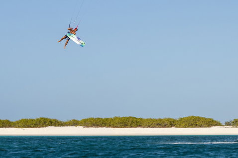 Duotone Jaime Concept Blue twin-tip kiteboard during kitesurfing at a tropical beach with mangroves and white sand