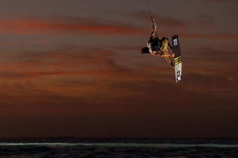Duotone Select Concept Blue twin-tip kiteboard during kitesurfing on ocean beach at sunset