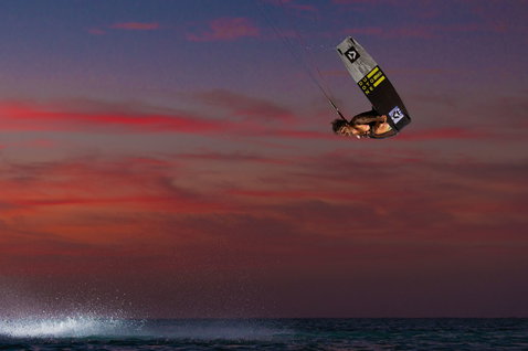 Duotone Select Concept Blue twin-tip kiteboard during kitesurfing at ocean beach at sunset