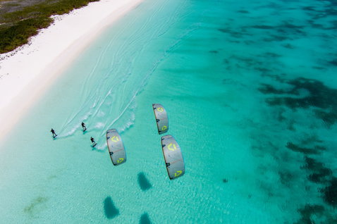Duotone Select Concept Blue twin-tip kiteboard during kitesurfing at a tropical beach with turquoise lagoon
