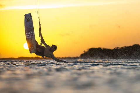 Duotone Select SLS twin-tip kiteboard during kitesurfing at the tropical coastline