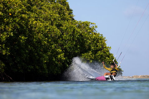 Duotone Soleil Concept Blue twin-tip kiteboard during kitesurfing in a tropical lagoon with mangroves