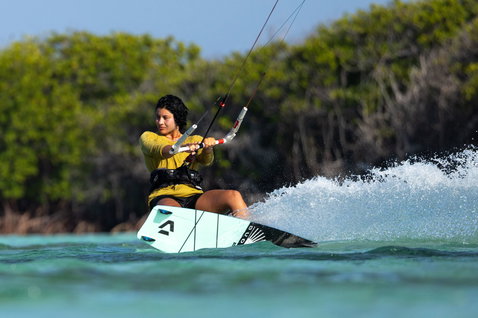 Duotone Soleil SLS twin-tip kiteboard during kitesurfing in a tropical lagoon with mangrove trees